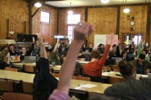 hands being raised by people during town meeting