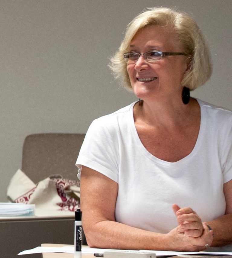 Beverley Burkett sitting at a desk