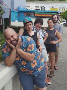 Roberto Lugo poses with Puerto Rican students in front of a wall