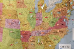 of map the United States with sticky notes marking certain states