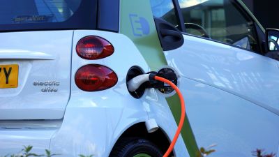 electric car being plugged into charging station