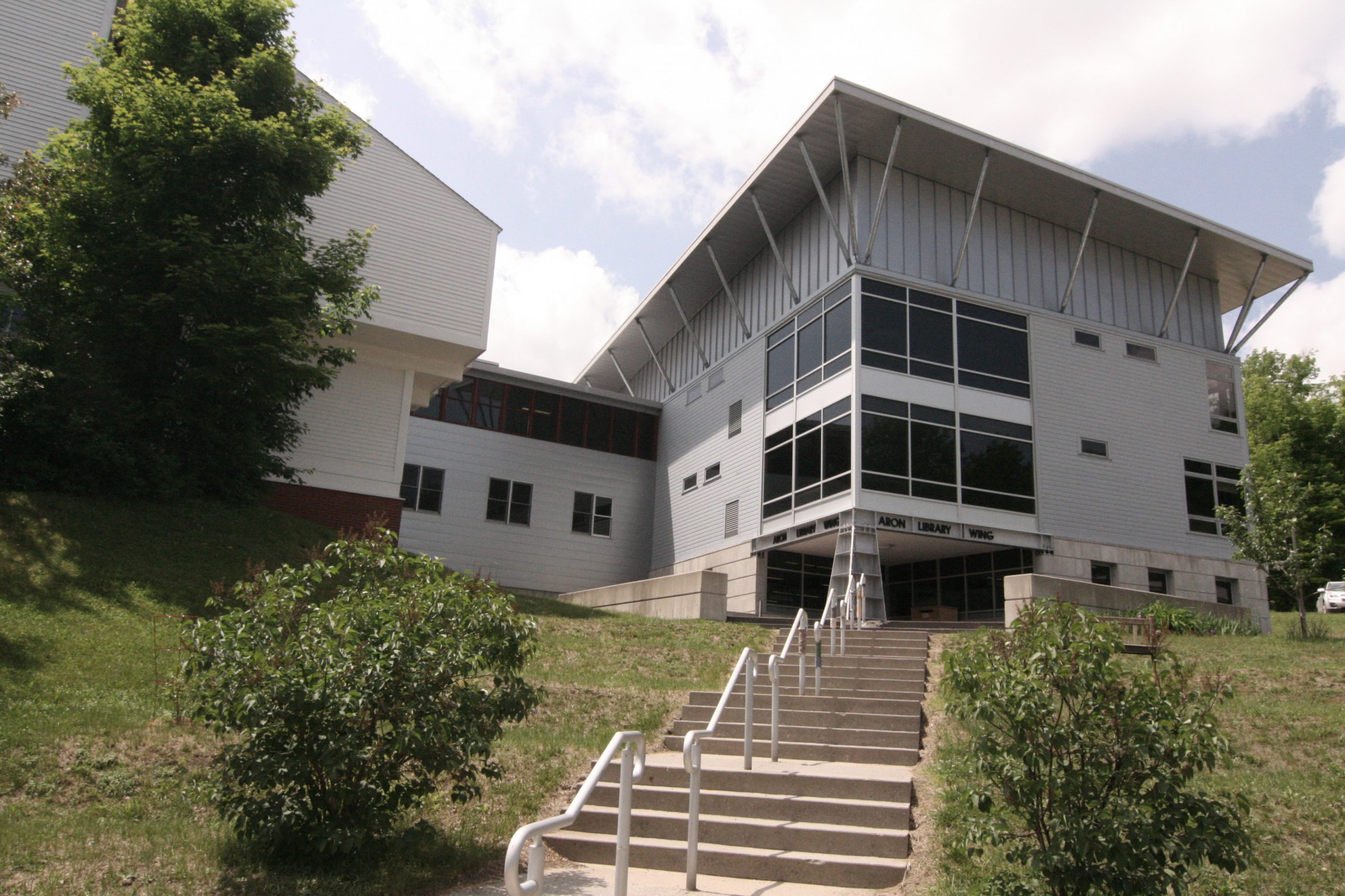 The exterior of the Rice-Aron library as seen from the bottom of the stairs leading to it