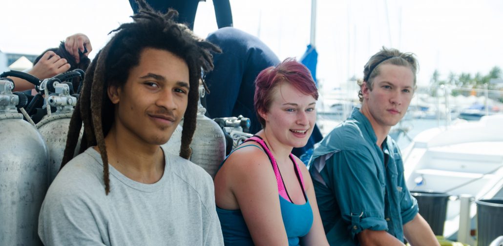 Menefese Kudumu-Clavell sitting next to two friends