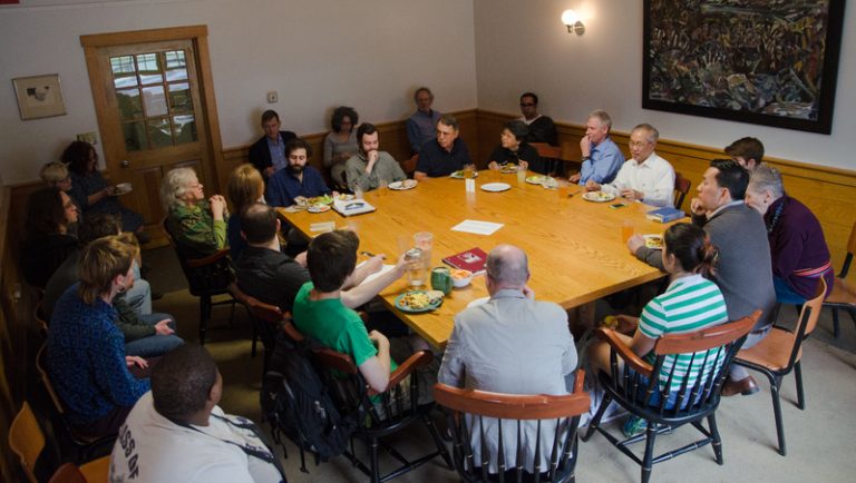 Group of faculty members sitting around a table having a discussion