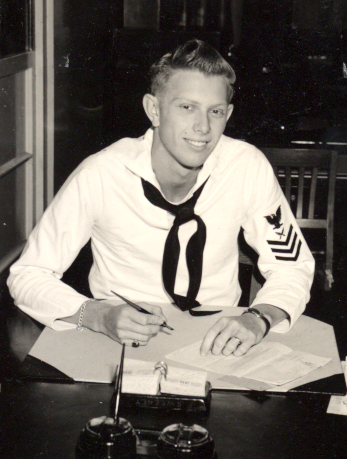 Jim Shingle seated at a desk wearing a navy uniform