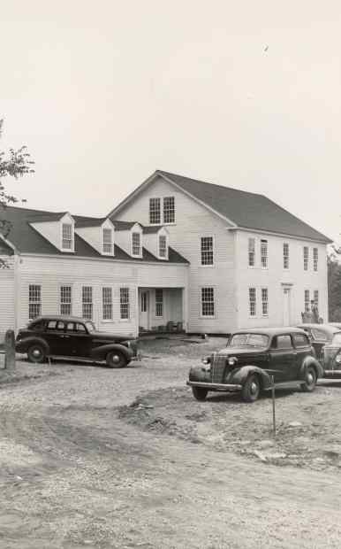 Image of the main Marlboro College building from the late 1940s with two cars in front