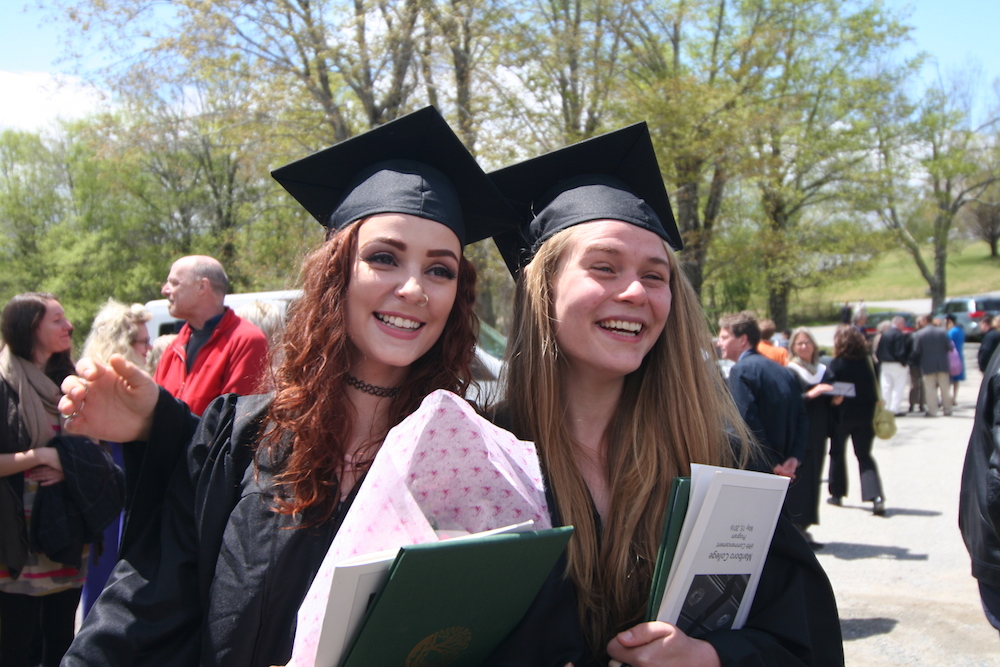 Two graduates pose
