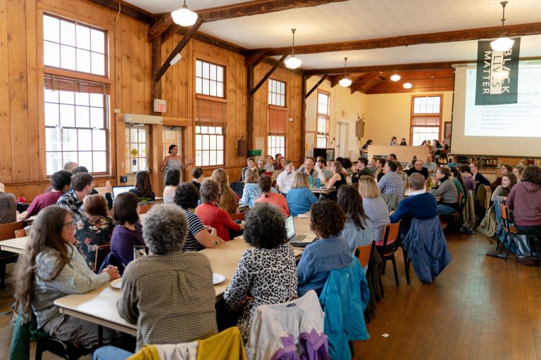 Students, faculty members, and staff members gathered at a town meeting