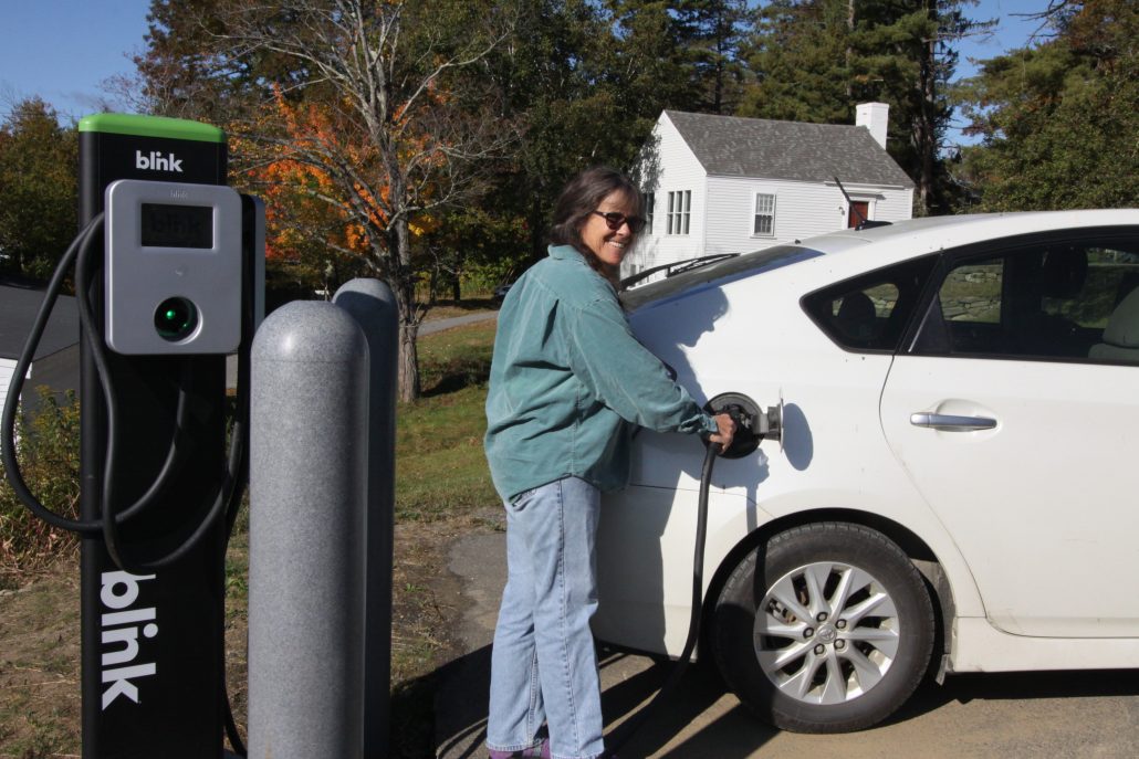 Jenny Ramstetter charging up a car at a EV charging station
