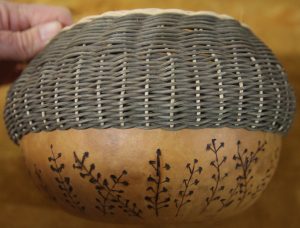 A homemade basket featuring elements of weaving and flora motifs