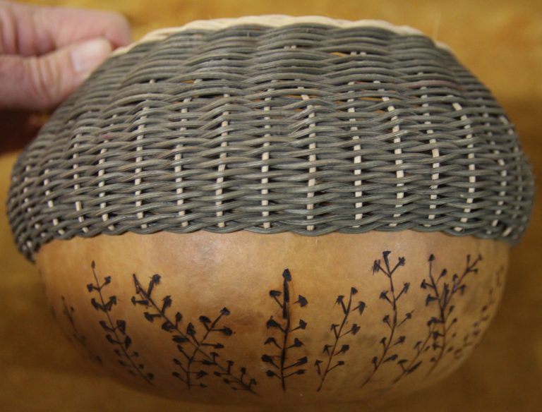 A homemade basket featuring elements of weaving and flora motifs