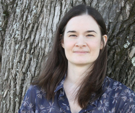 Close up of Jennifer standing in front of a tree