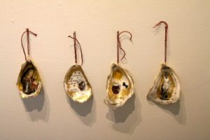four shells with paintings inside